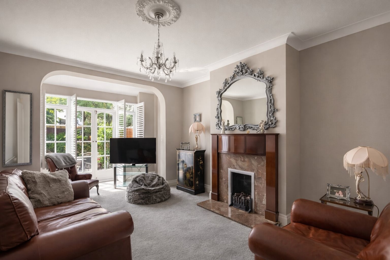 Lounge with a fireplace and garden doors at Cleveland Park, W13